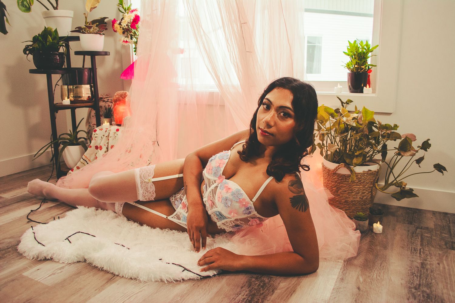 Lifestyle boudoir photography in home setting with plants and natural light.