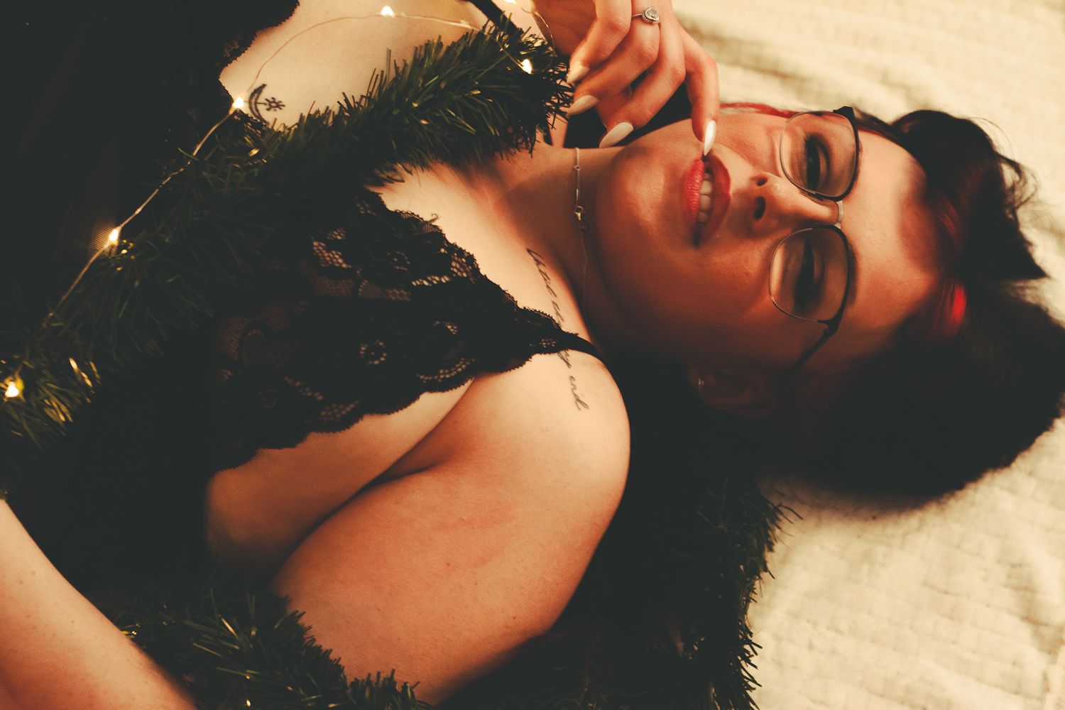 Sensual portrait featuring black lace and warm lighting effects.