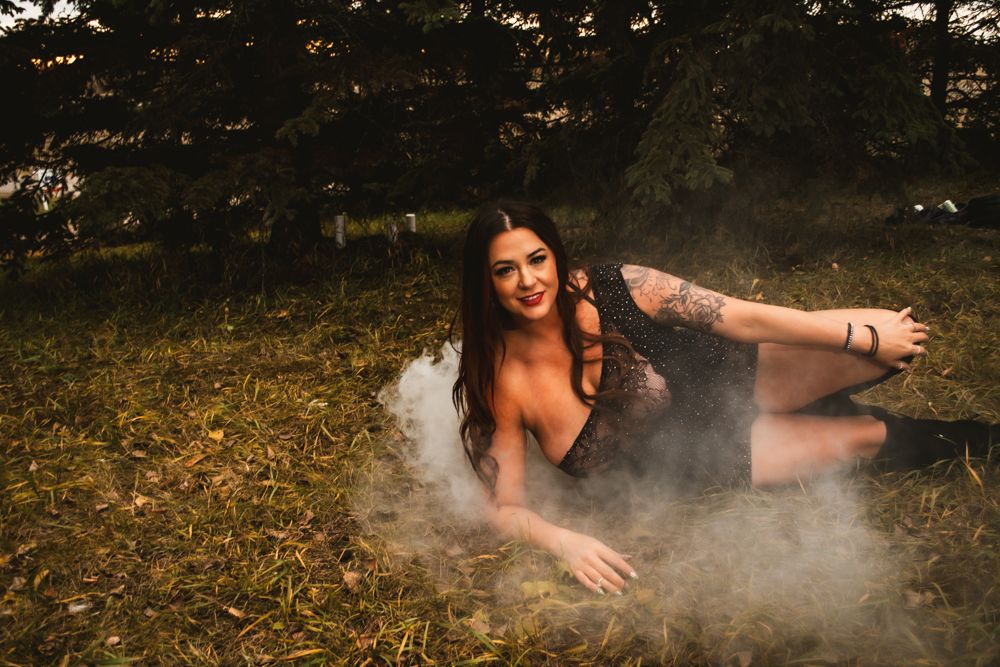 Dramatic outdoor photography with misty smoke effects on forest floor.