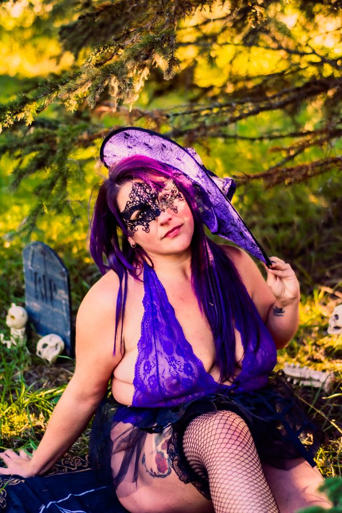 Enchanted forest scene with purple decor and gothic Halloween accessories.