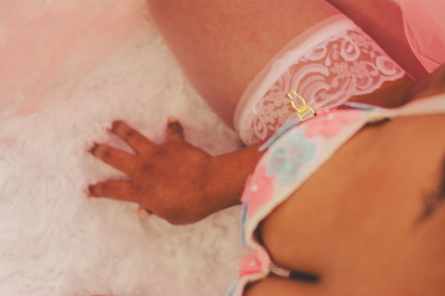 Intimate detail shot of lace trimming and floral patterns in warm lighting.