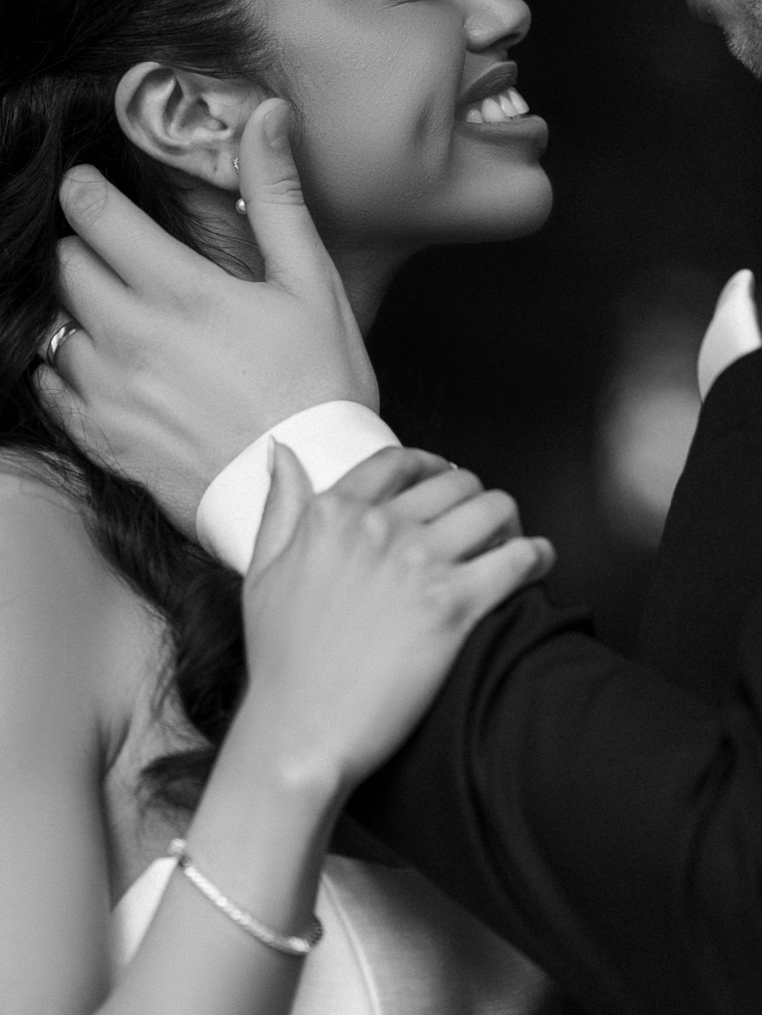 A romantic black and white series of close-up shots showing intimate moments between a couple embracing.