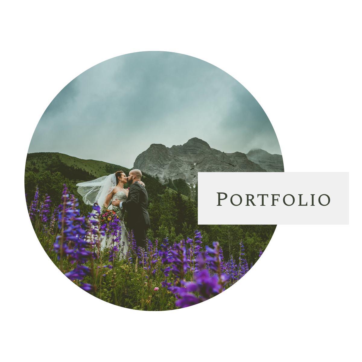 A couple poses in front of a mountain landscape with purple wildflowers blooming in a scenic outdoor setting.