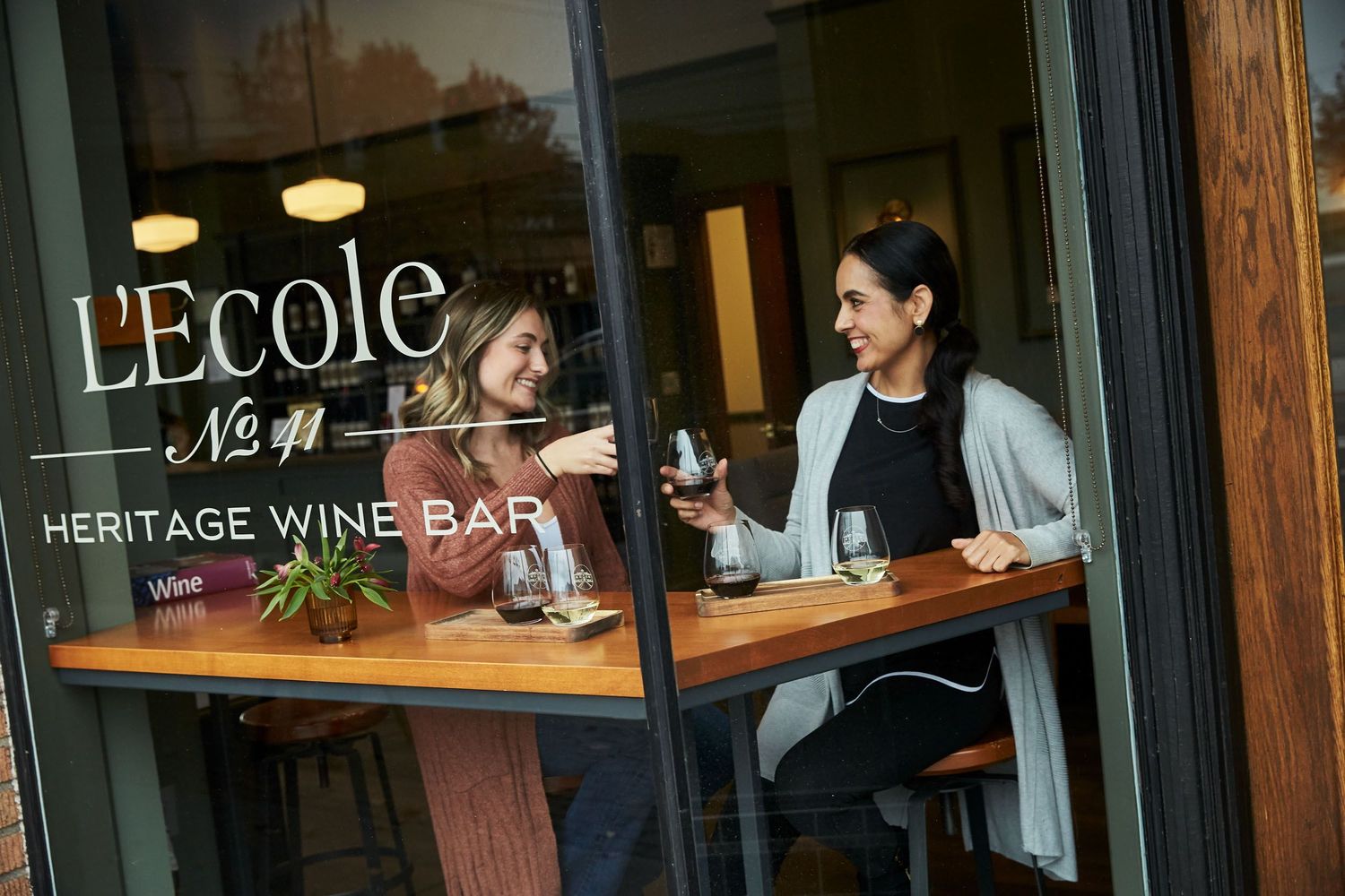 Heritage Wine Bar storefront with warm lighting and rustic wooden exterior.