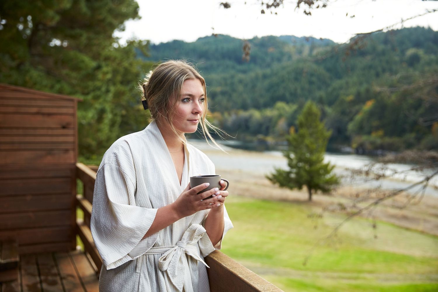 Peaceful outdoor scene with patio seating overlooking mountain landscape.