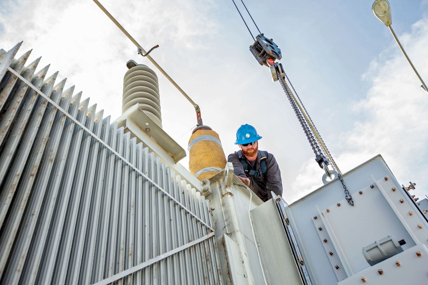 Electrical transformer maintenance work being performed on high voltage equipment.