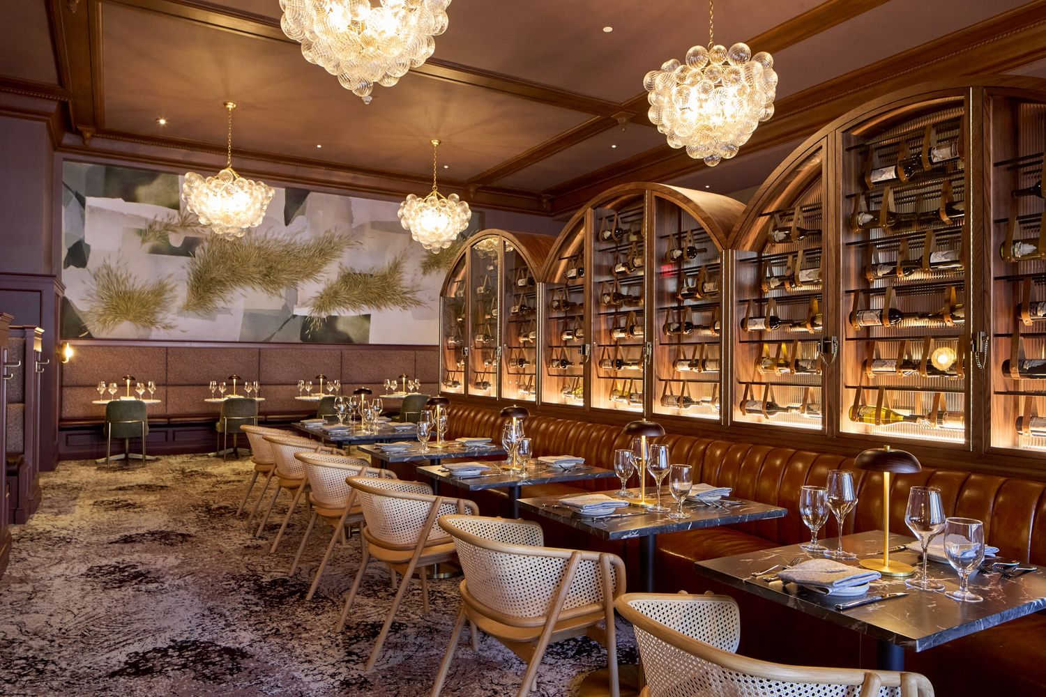 Upscale dining room with crystal chandeliers and intimate table settings.
