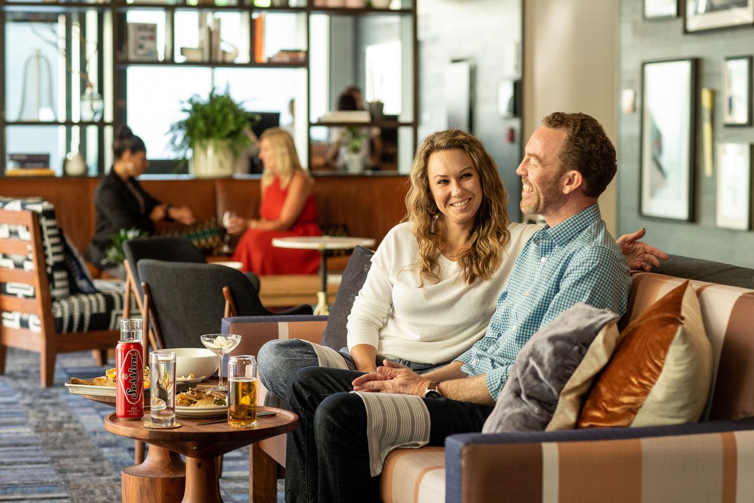 Cozy restaurant lounge area with comfortable seating and warm lighting.