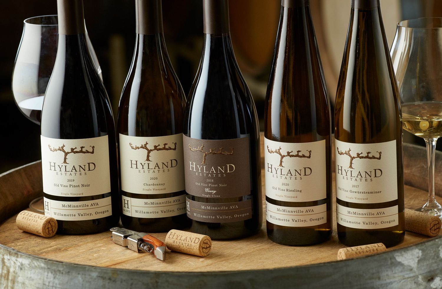 Row of artisanal wine bottles displayed on a wooden shelf.