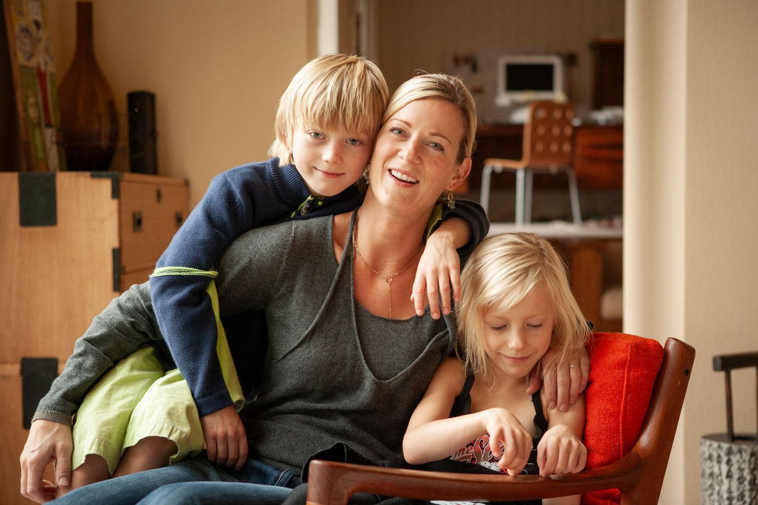 Family relaxing together on comfortable chair at home.
