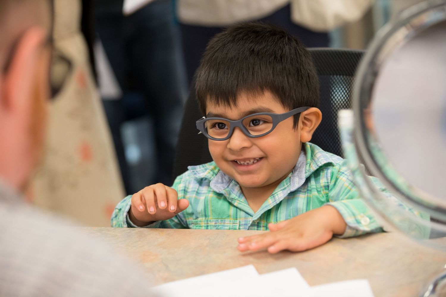 Young student working at desk in classroom setting.