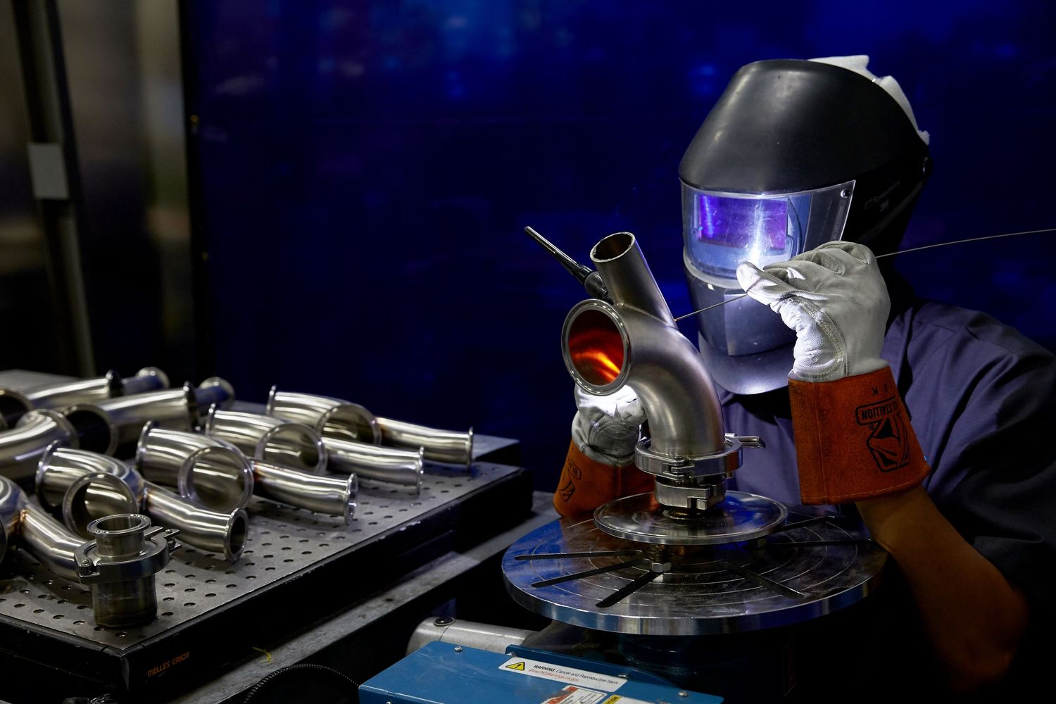 Scientific laboratory equipment illuminated by blue light during testing procedures.