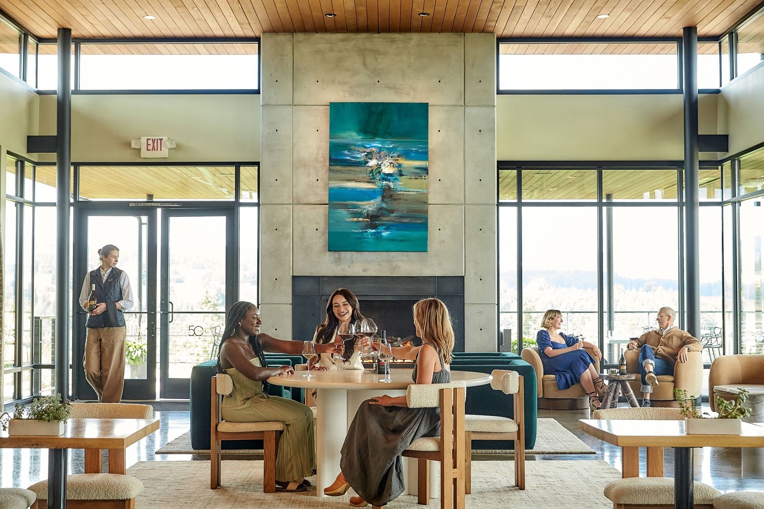 Modern winery tasting room interior with wood ceiling and large windows.
