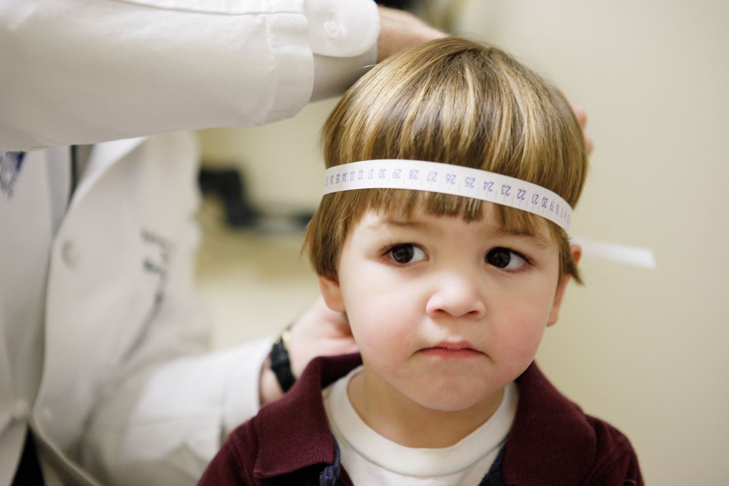 Young patient getting eye examination with medical equipment.