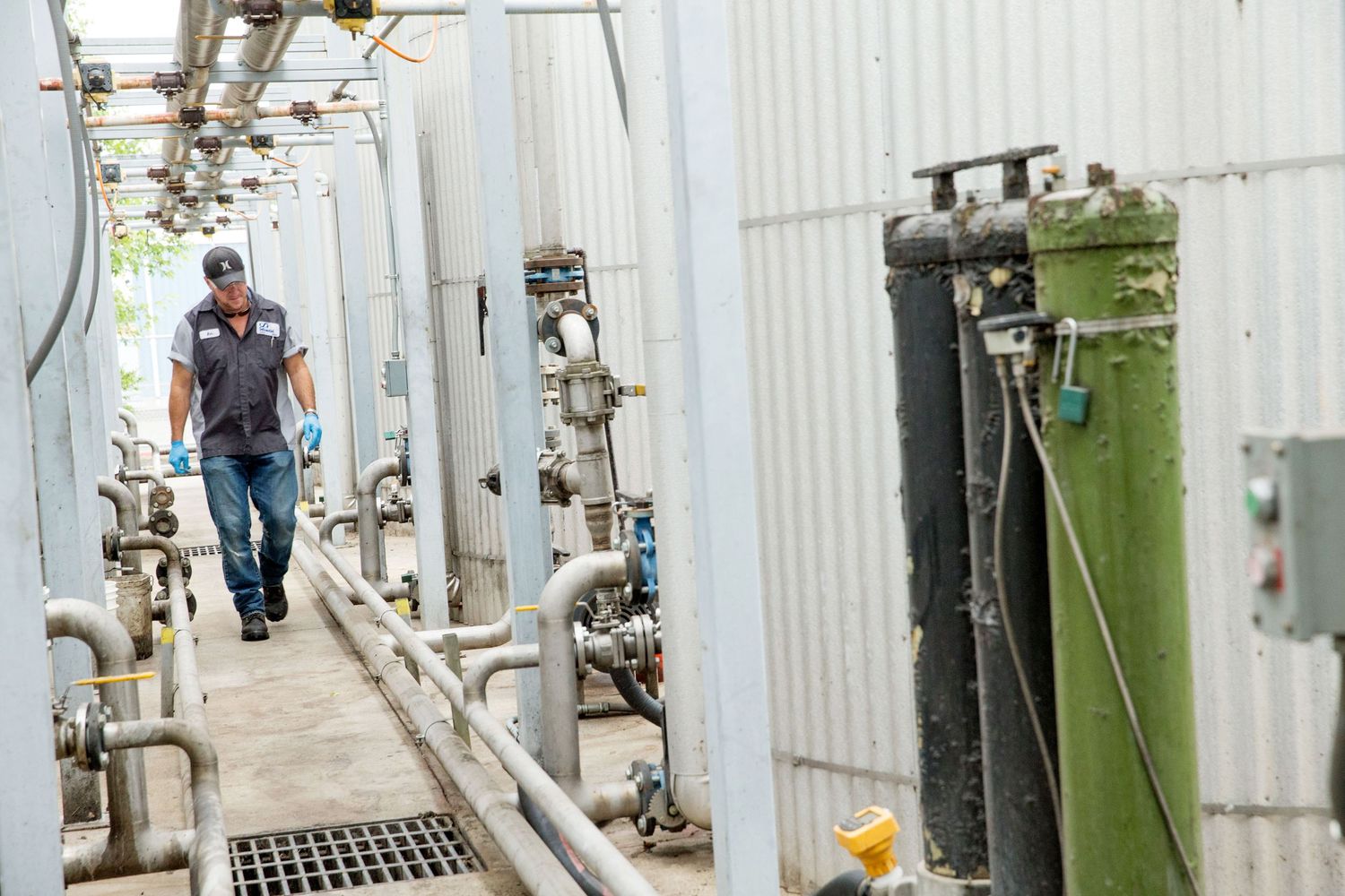 Industrial equipment and machinery in white-walled facility corridor.