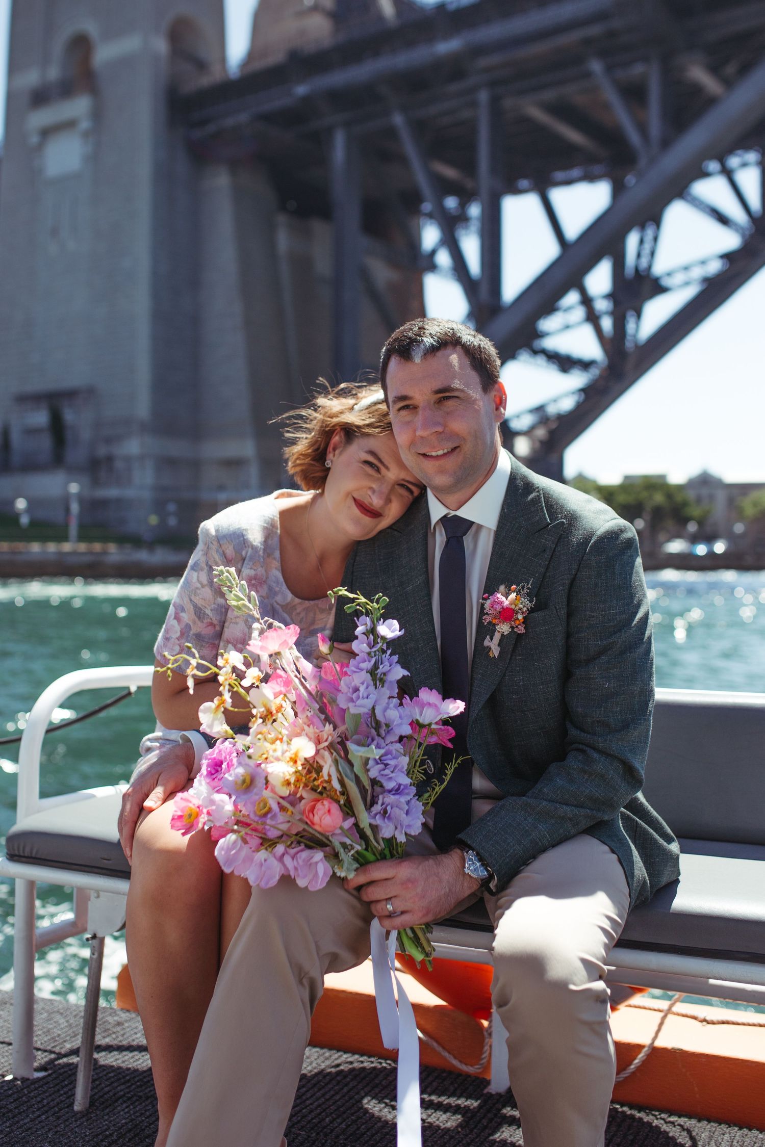 Bride and groom smiling on boat after intimate wedding in Sydney NSW
