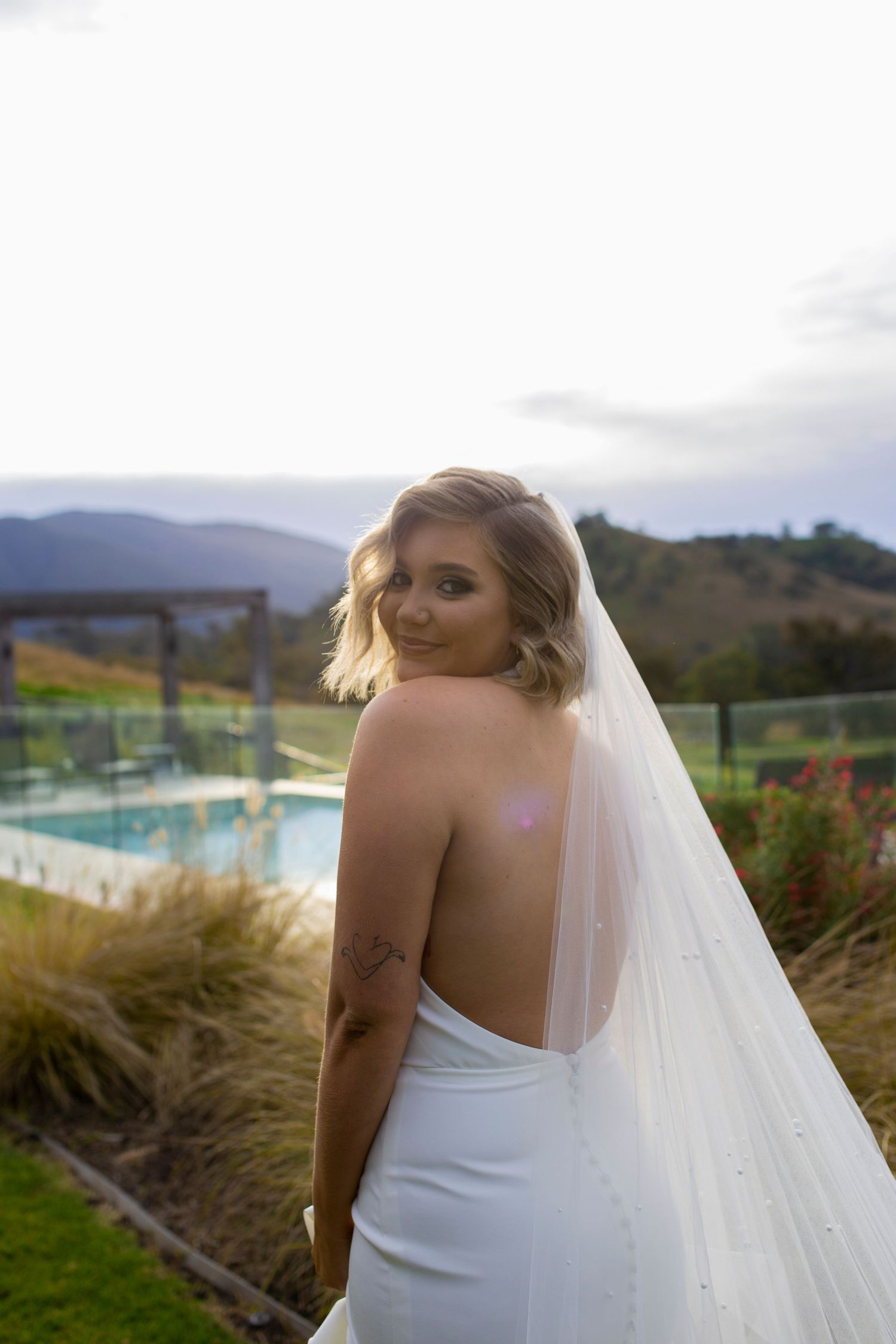 Bride smiling over shoulder at Scone country Wedding