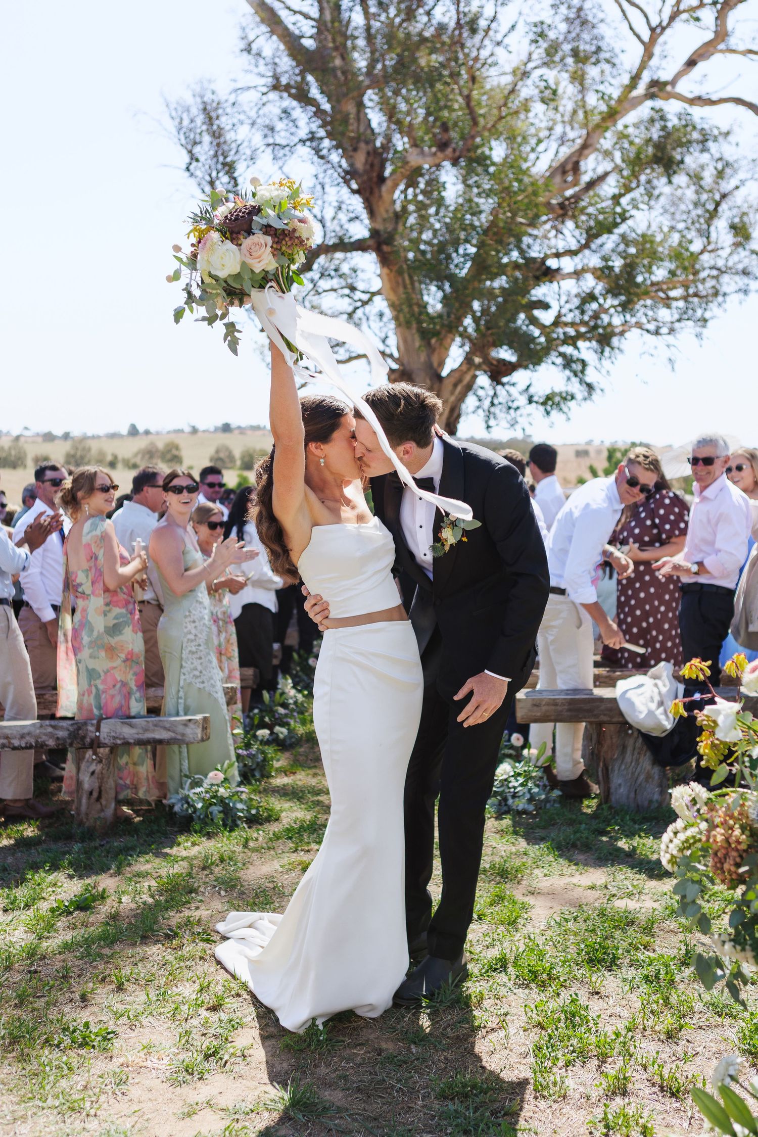 newlyweds kissing at end of the aisle at country NSW wedding