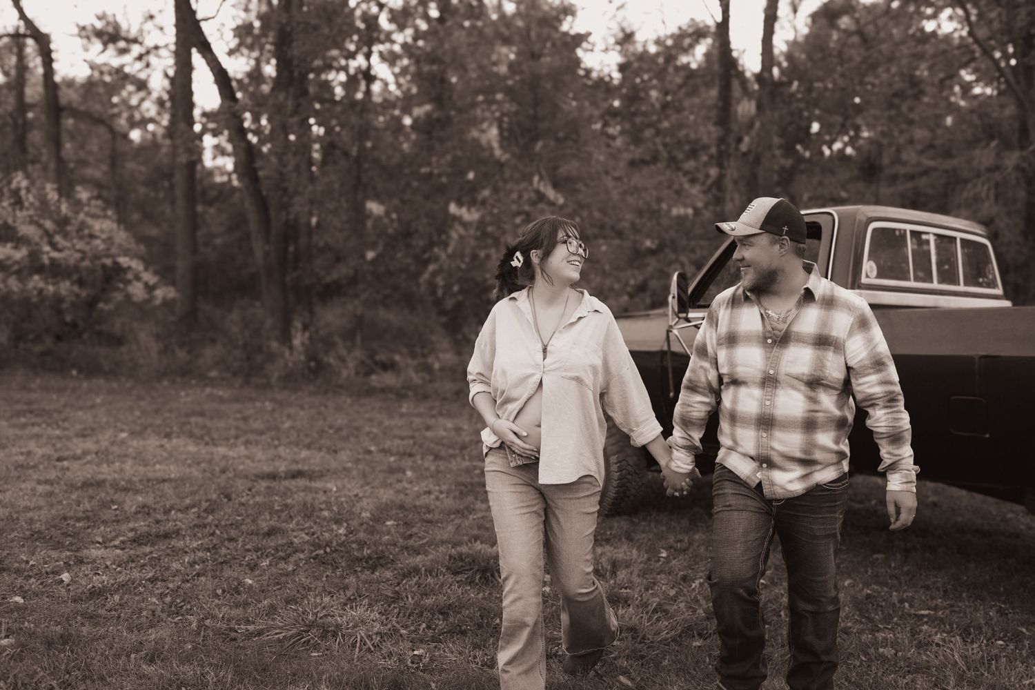 Couple, walk together during their maternity session in Ana, OH. Photographed by Vicci Photo of Dayton OH