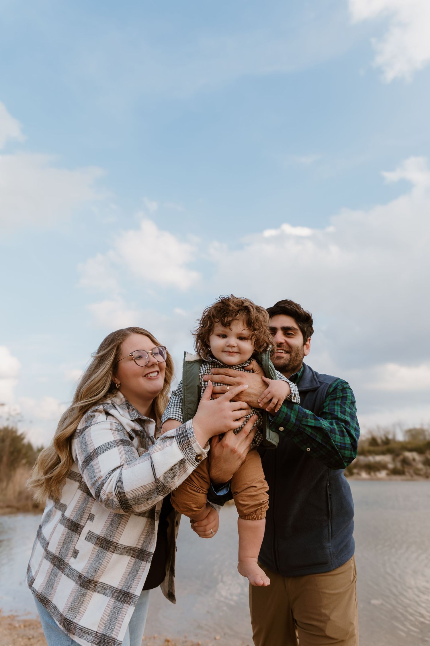 Family embraces during a family session at Oakes Quarry in Fairborn, OH. Photographed by Vicci Photo of Dayton, OH