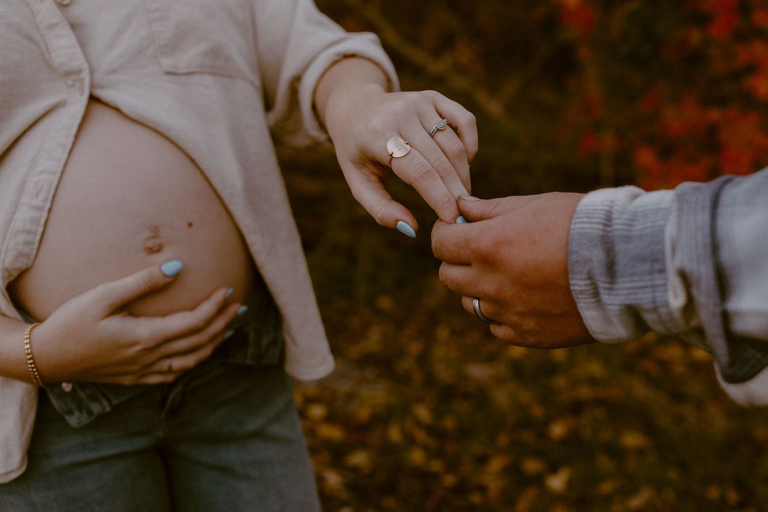 Couple show off mom's pregnant belly during their maternity session in Ana, OH. Photographed by Vicci Photo of Dayton OH