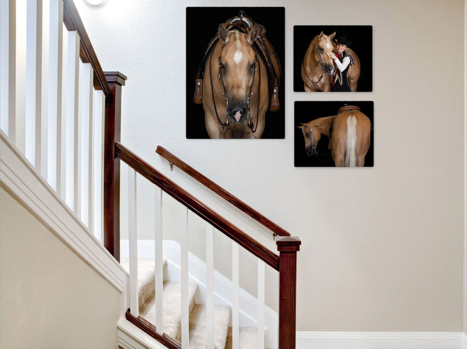Three horse portraits arranged on a stairway wall creating an elegant gallery display.