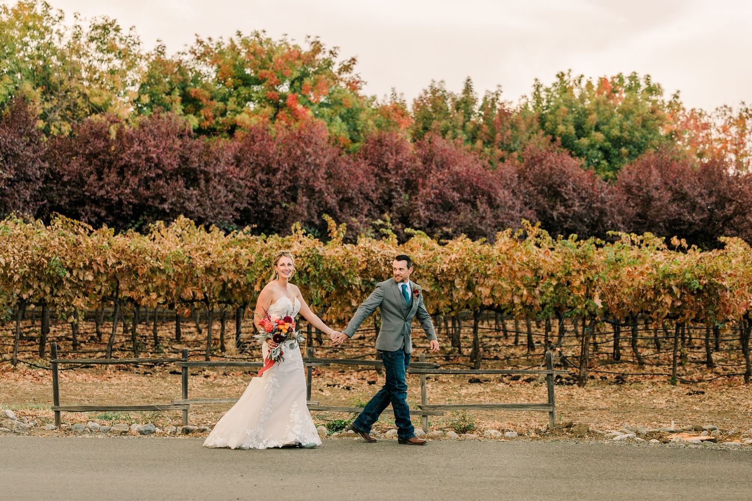 A romantic vineyard photo session at sunset with grapevines and warm autumn colors in the background.