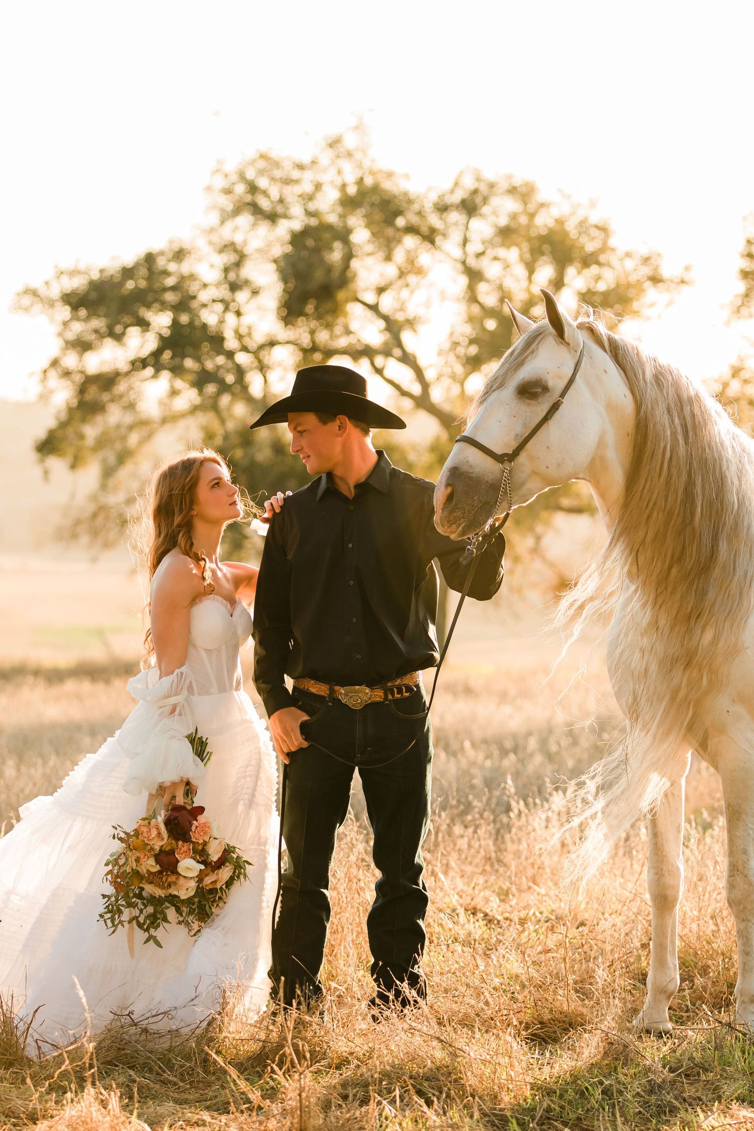 Cowboy couple with their horse during bridal portraits in Northern California captured by Ranch Wedding Photographer Lauren Ann Photography