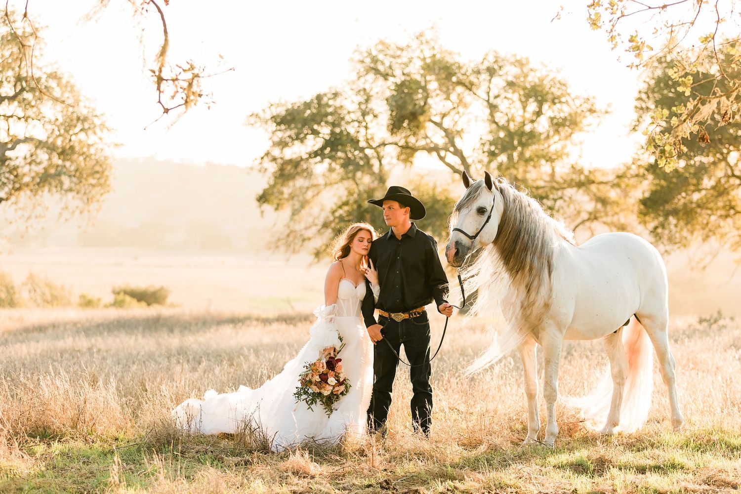 Wedding couple shares romantic moments in golden sunset light across scenic outdoor meadow landscape.