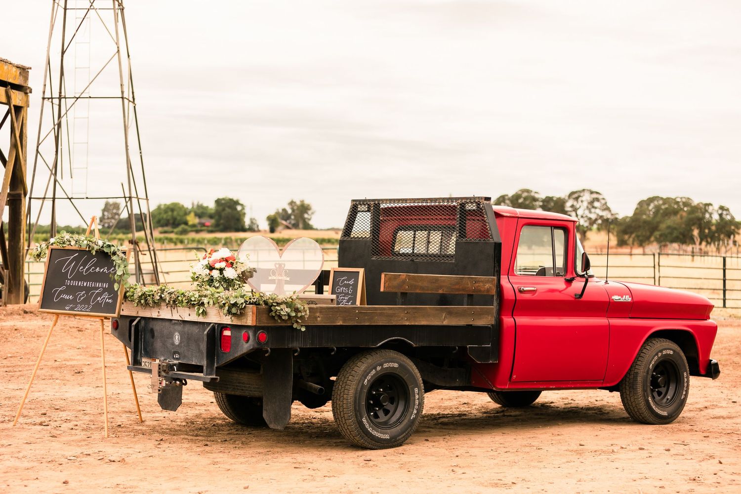 A collage shows four photos of vintage red trucks and trailers parked in an arid desert landscape.