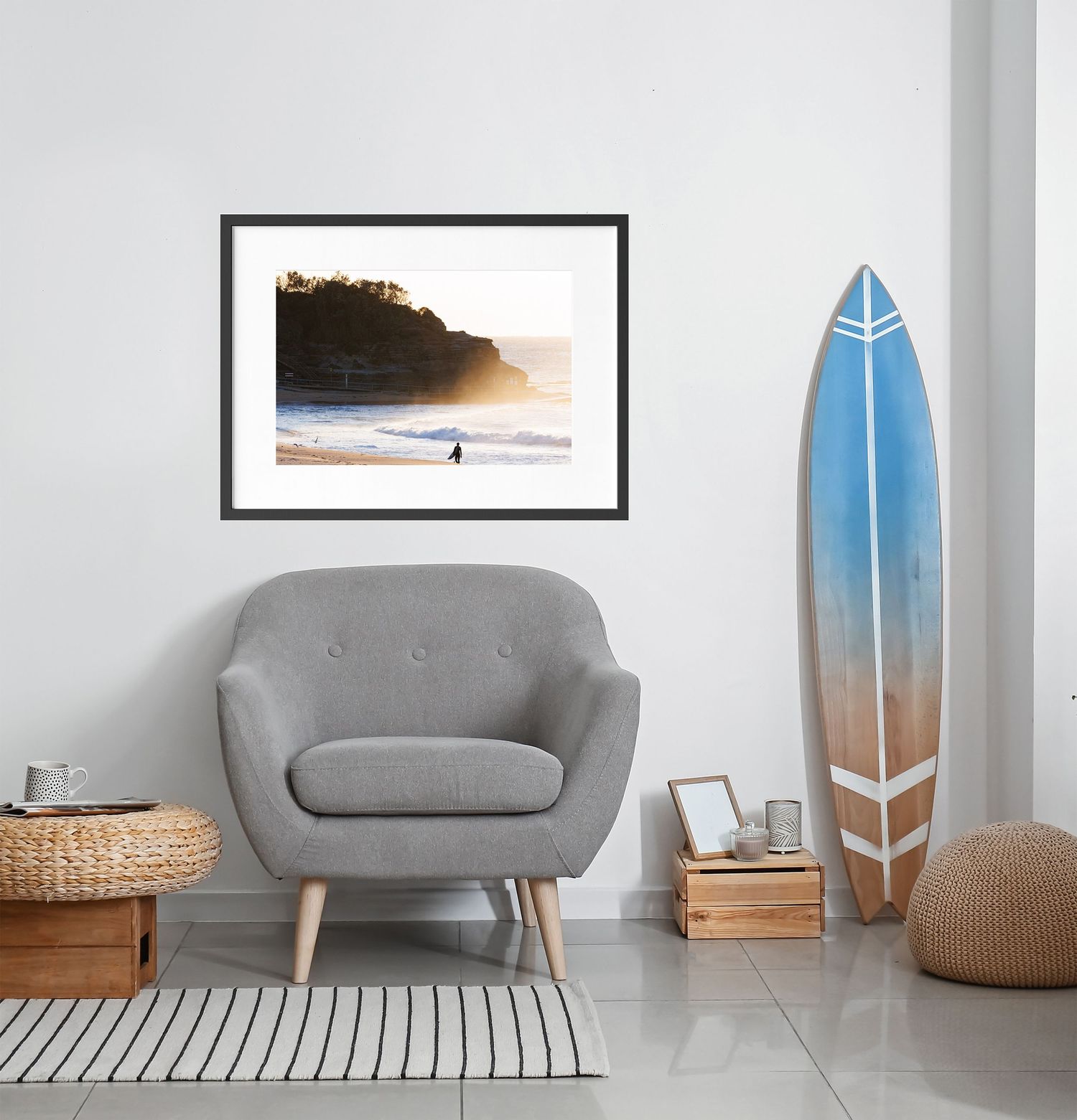 A picture of a surfer walking along Narrabeen Beach