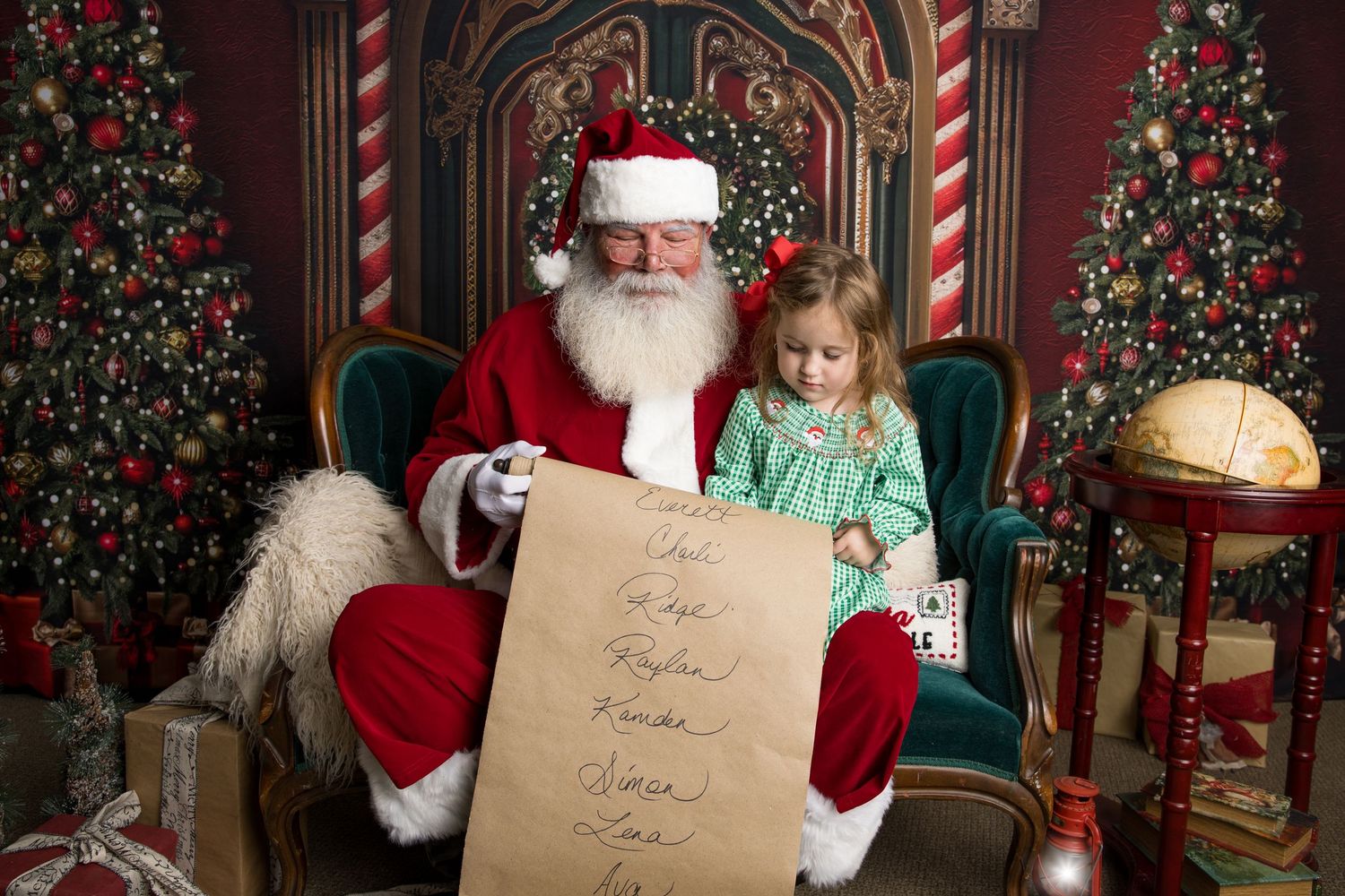 Holiday scene with decorated Christmas trees, striped candy cane columns, and a festive chair decorated in traditional red.