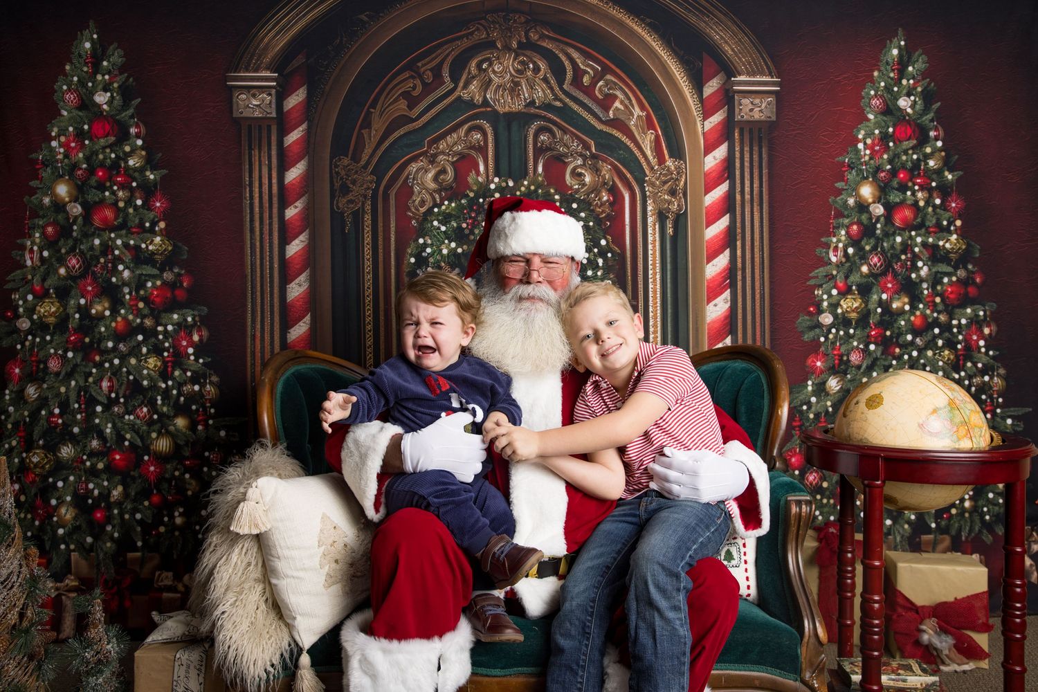 Traditional holiday scene with decorated Christmas trees, candy cane columns and a classic red velvet throne.