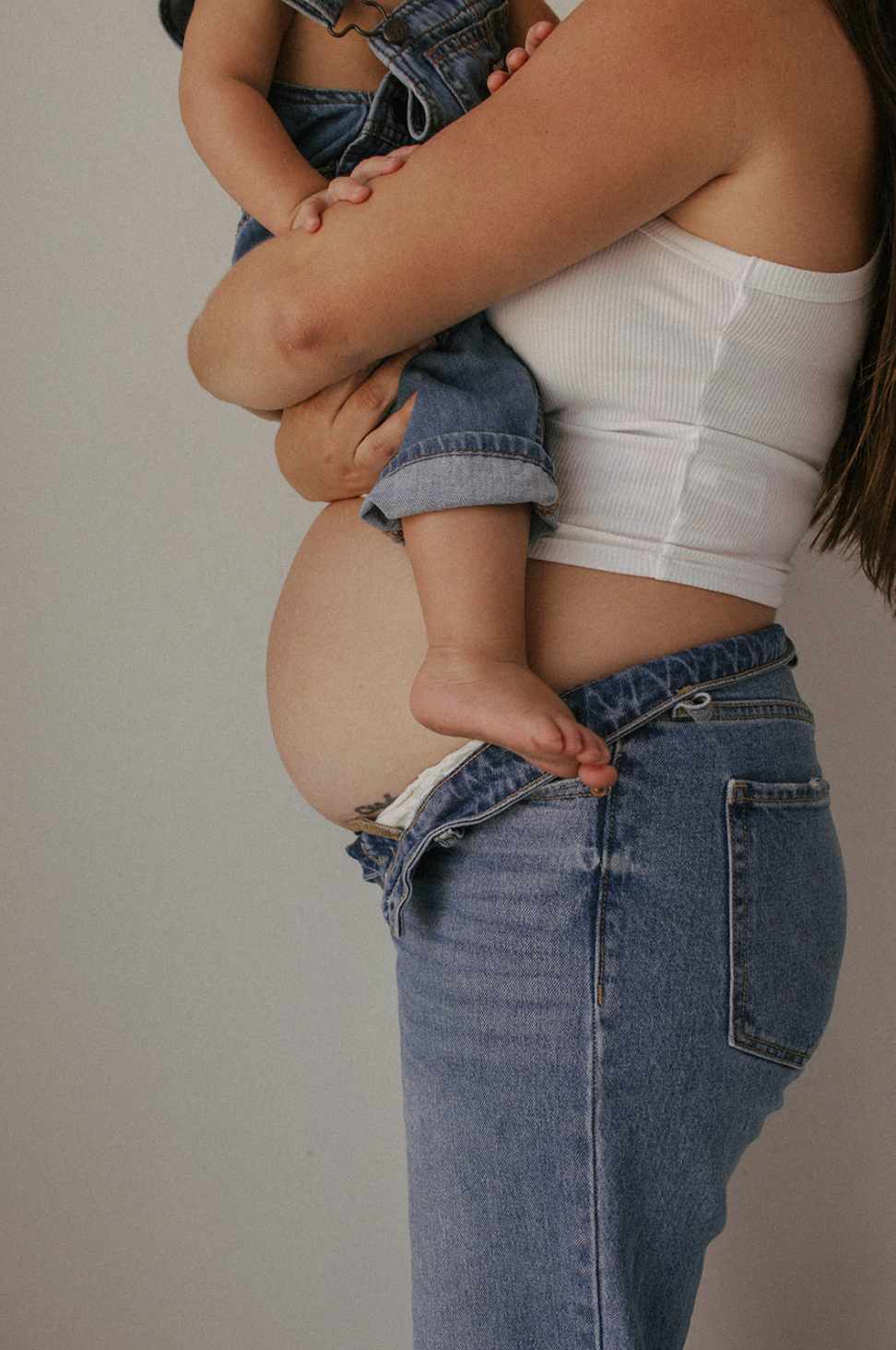 Close-up photo of mom, son, and baby bump taken at the Lumen Room Denton, TX