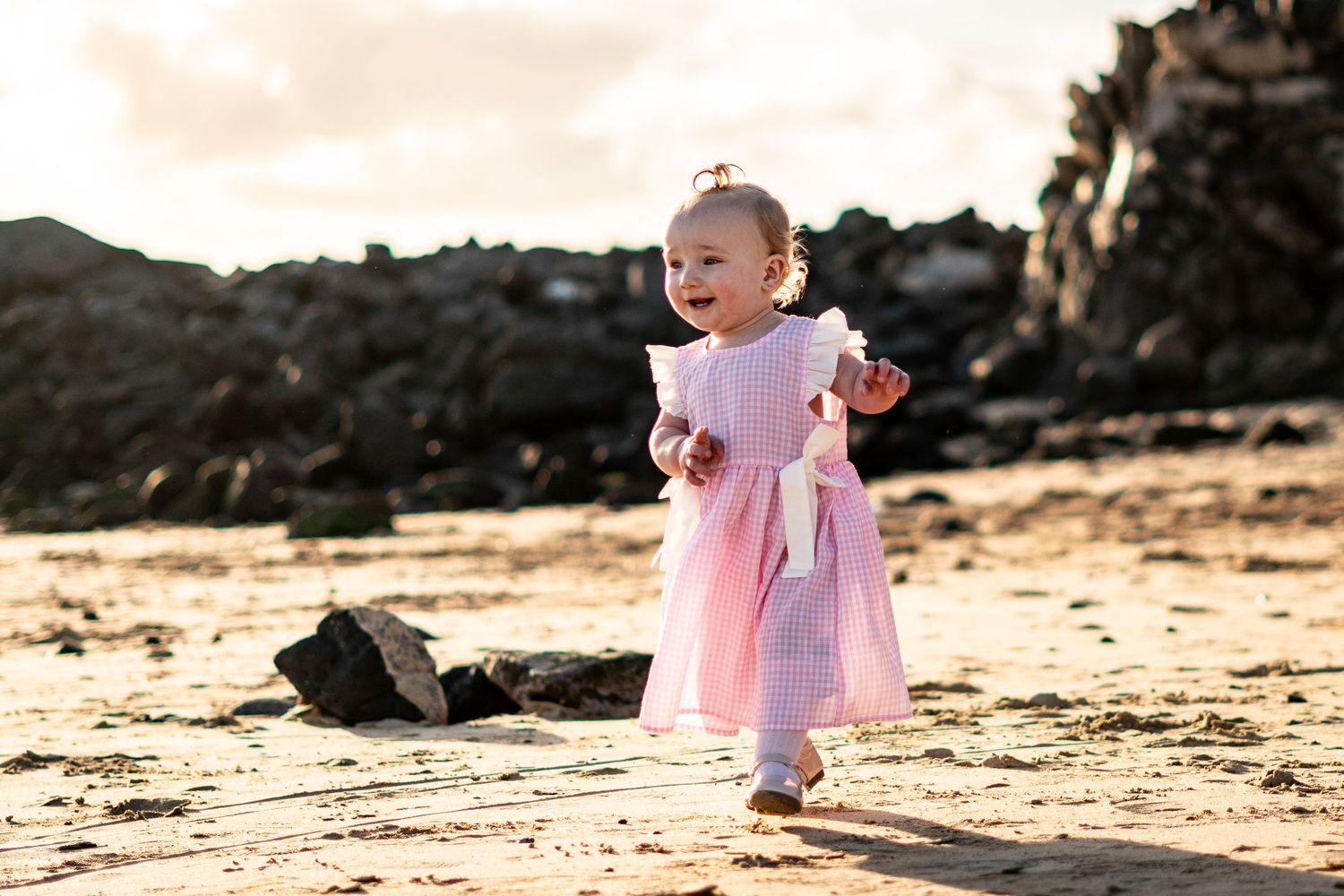 Children playing on black sand beach during family 
photo session, Lanzarote Canary Islands