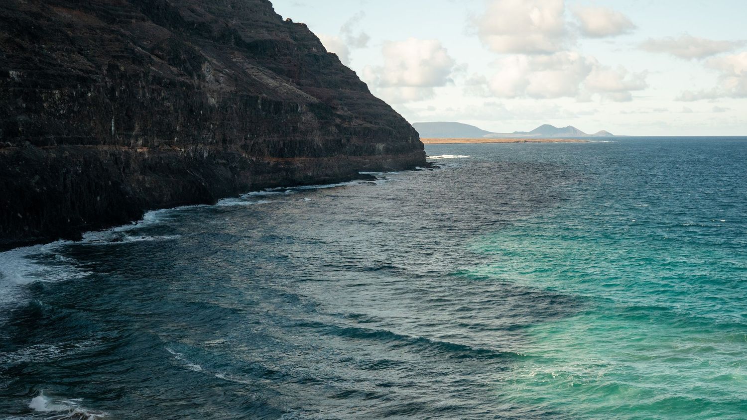 Black sand volcanic beach Lanzarote dramatic 
landscape — cinematic photography Del Puerto Creative