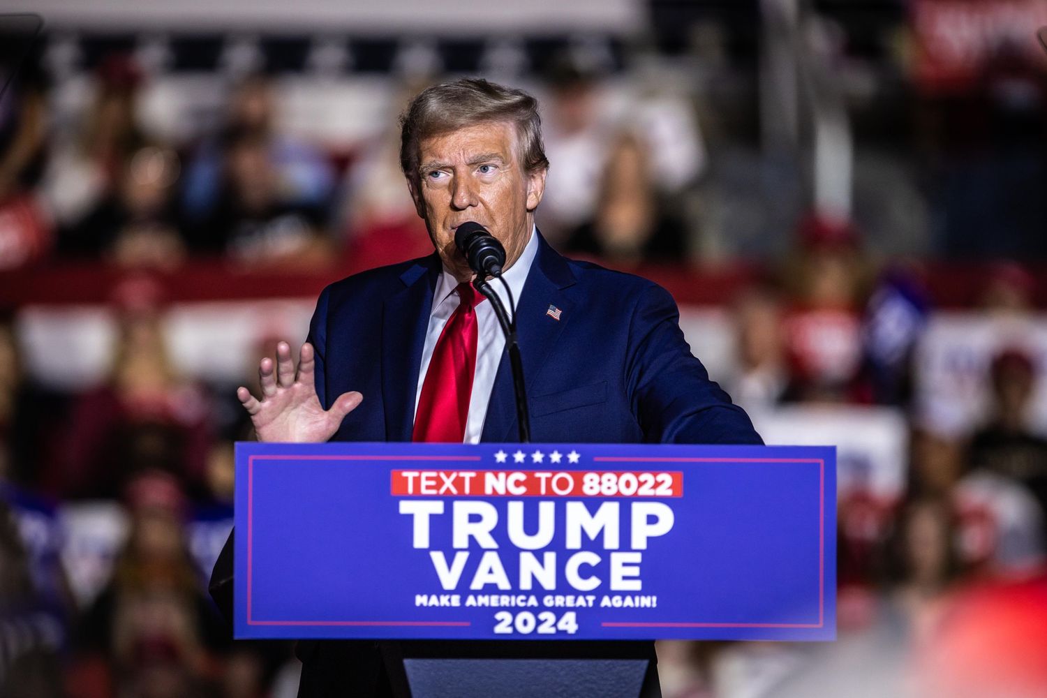 Donald Trump speaks at a Trump Vance Make America Great Again 2024 campaign rally podium in North Carolina.