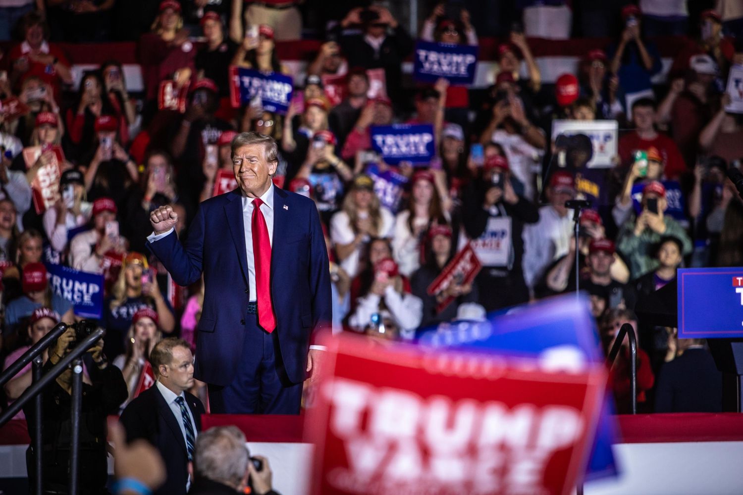 Donald Trump gestures at packed Trump Vance 2024 presidential campaign rally.