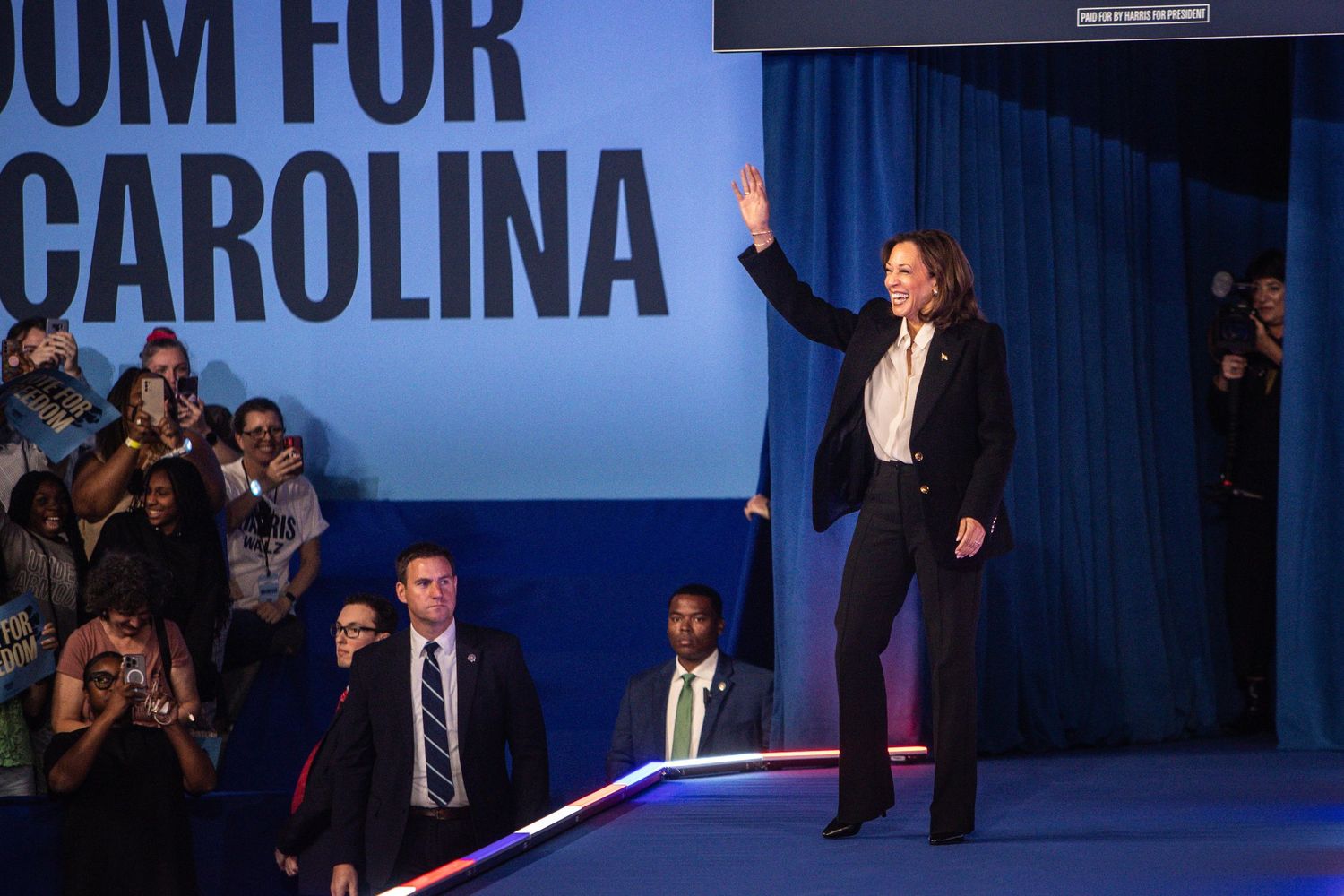 Kamala Harris waves to supporters at a Freedom for North Carolina campaign event.