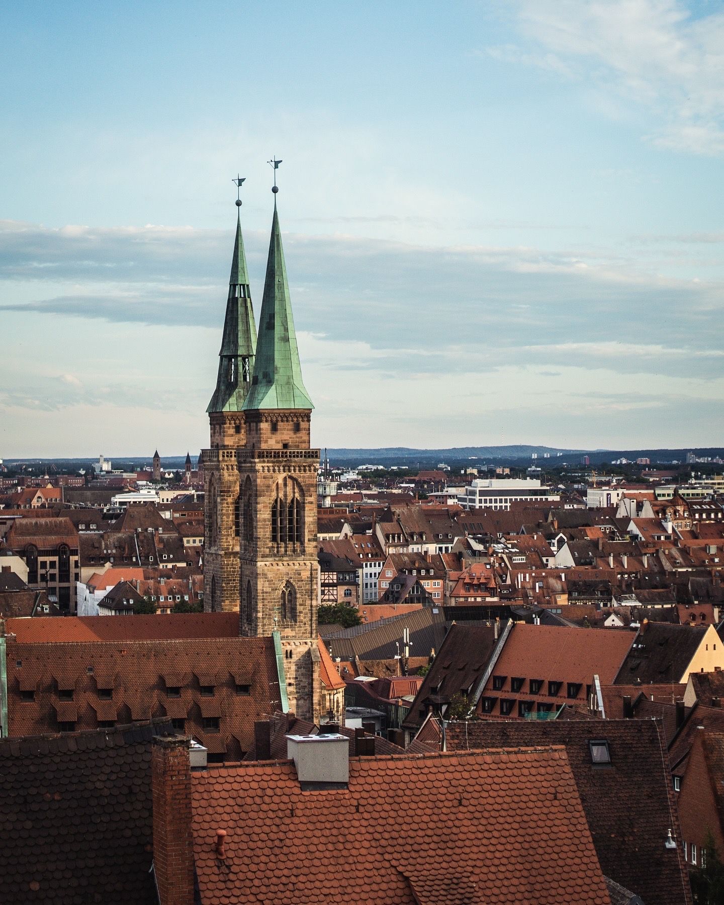 Aerial view of Nuremberg cityscape featuring the twin spires of St. Lorenz Church.