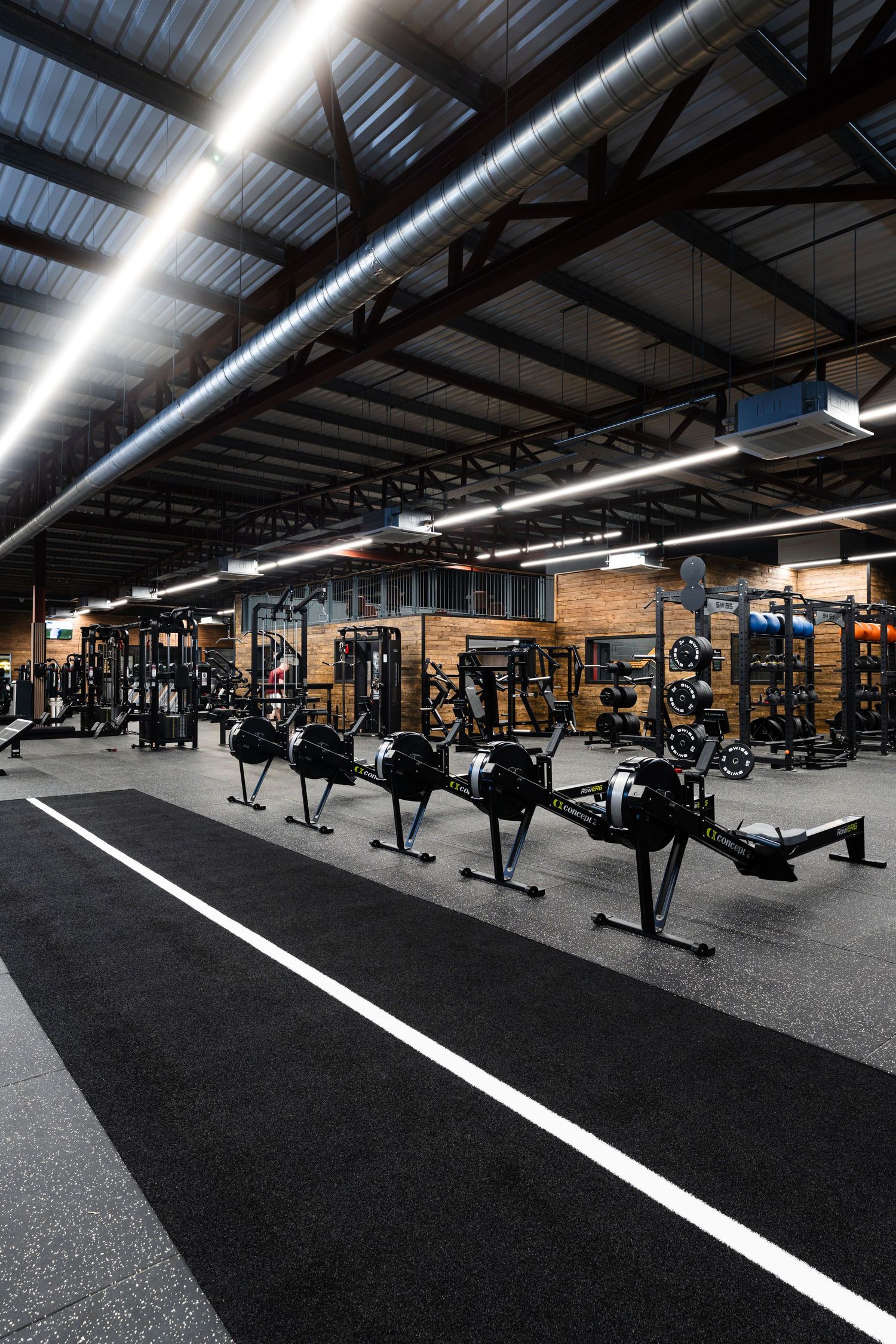 Hyrox area with rowing machines in open gym floor Bangor