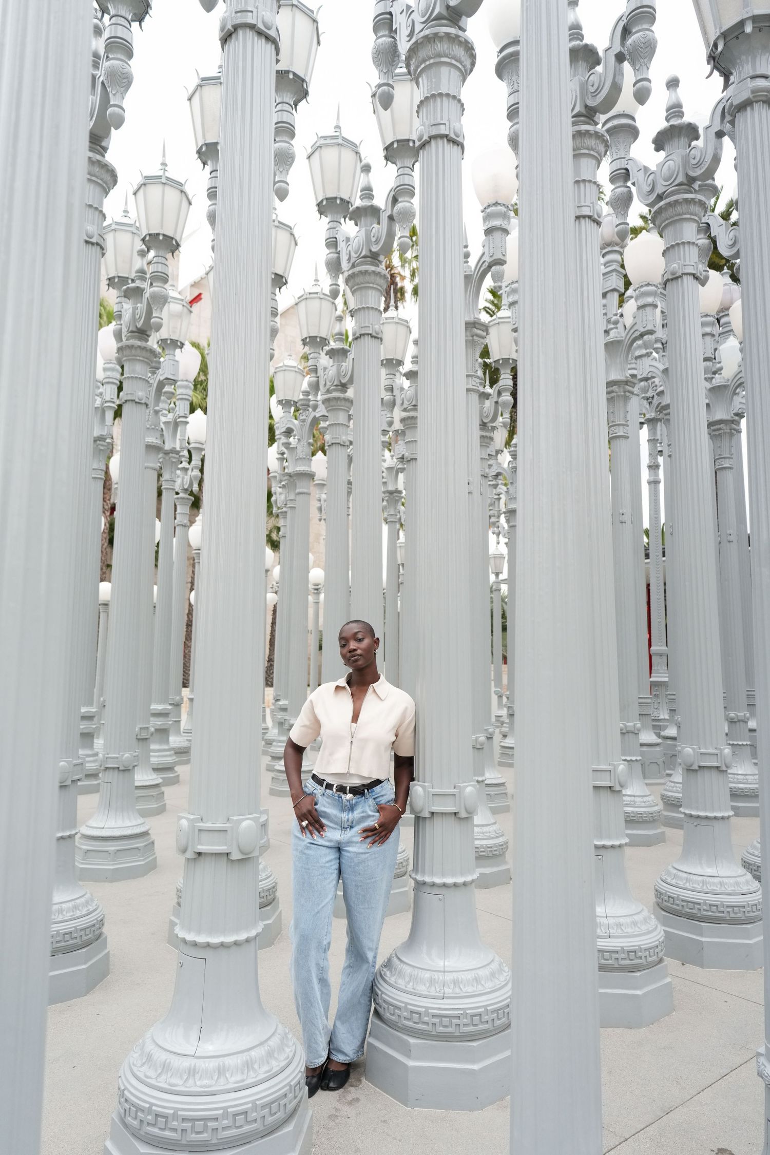 Portrait among tall gray lamp posts at LACMA's Urban Light installation in Los Angeles.
