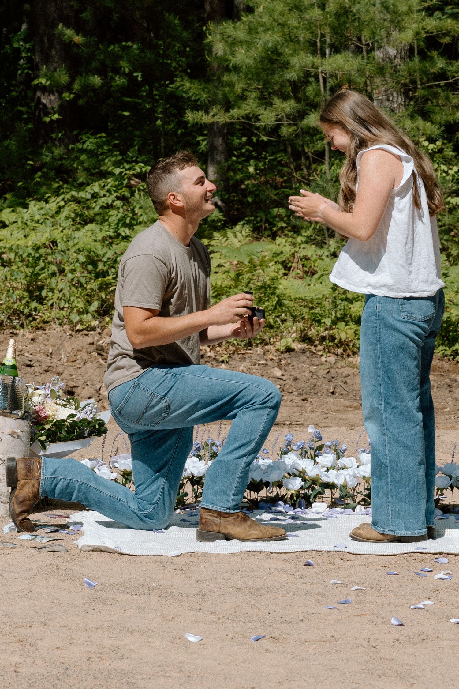 proposal celebration, cowboy boots, flowers, champagne, picnic, bride-to-be, proposal
