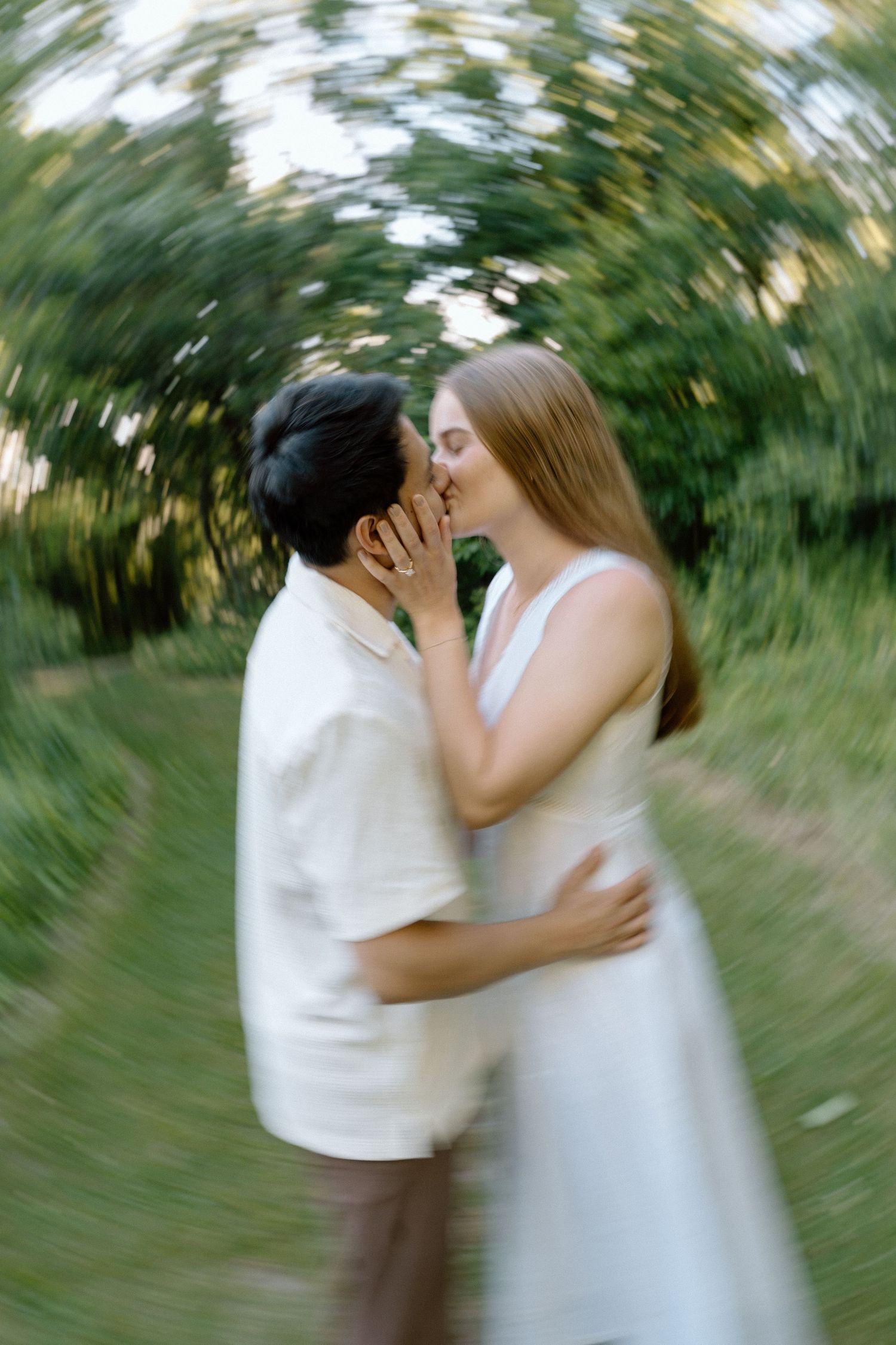an engagement shoot in a field on a summer evening