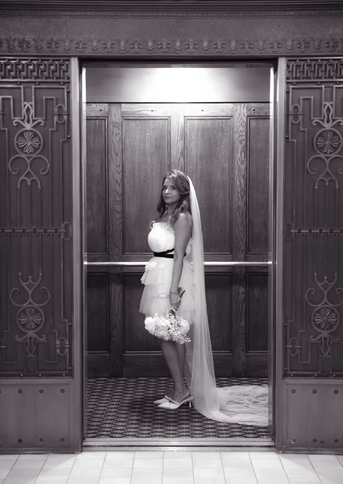 A wedding party enters through ornate wooden doors in a church hallway shown in a series of four black and white photos.