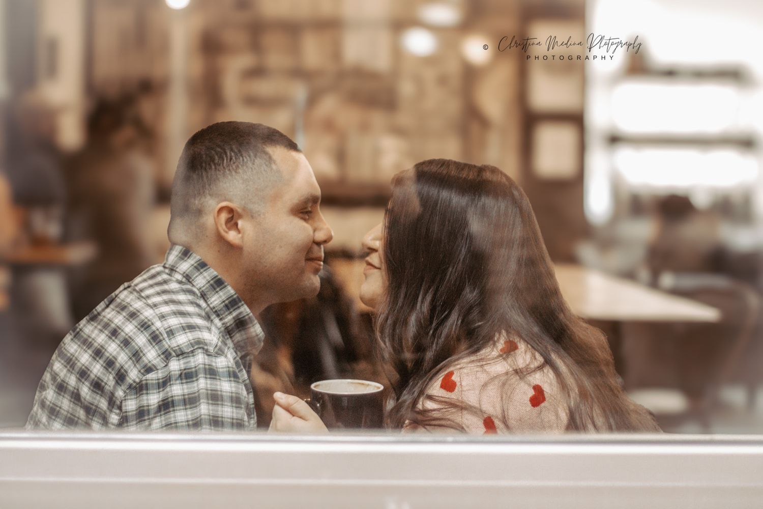 People enjoying coffee and conversation at a warm, inviting cafe with soft lighting and rustic ambiance.