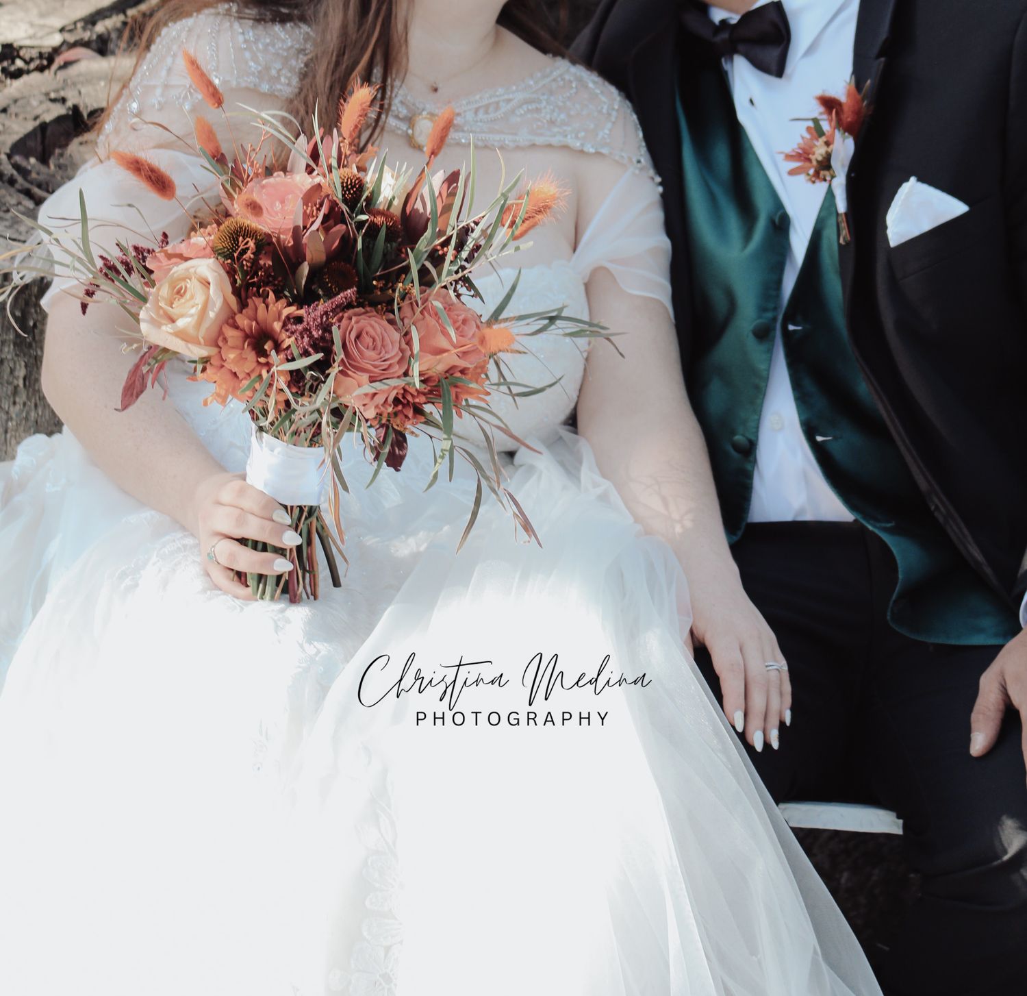 Close-up wedding photo details showing white dress fabric and autumn-colored dried floral bouquet with natural textures.