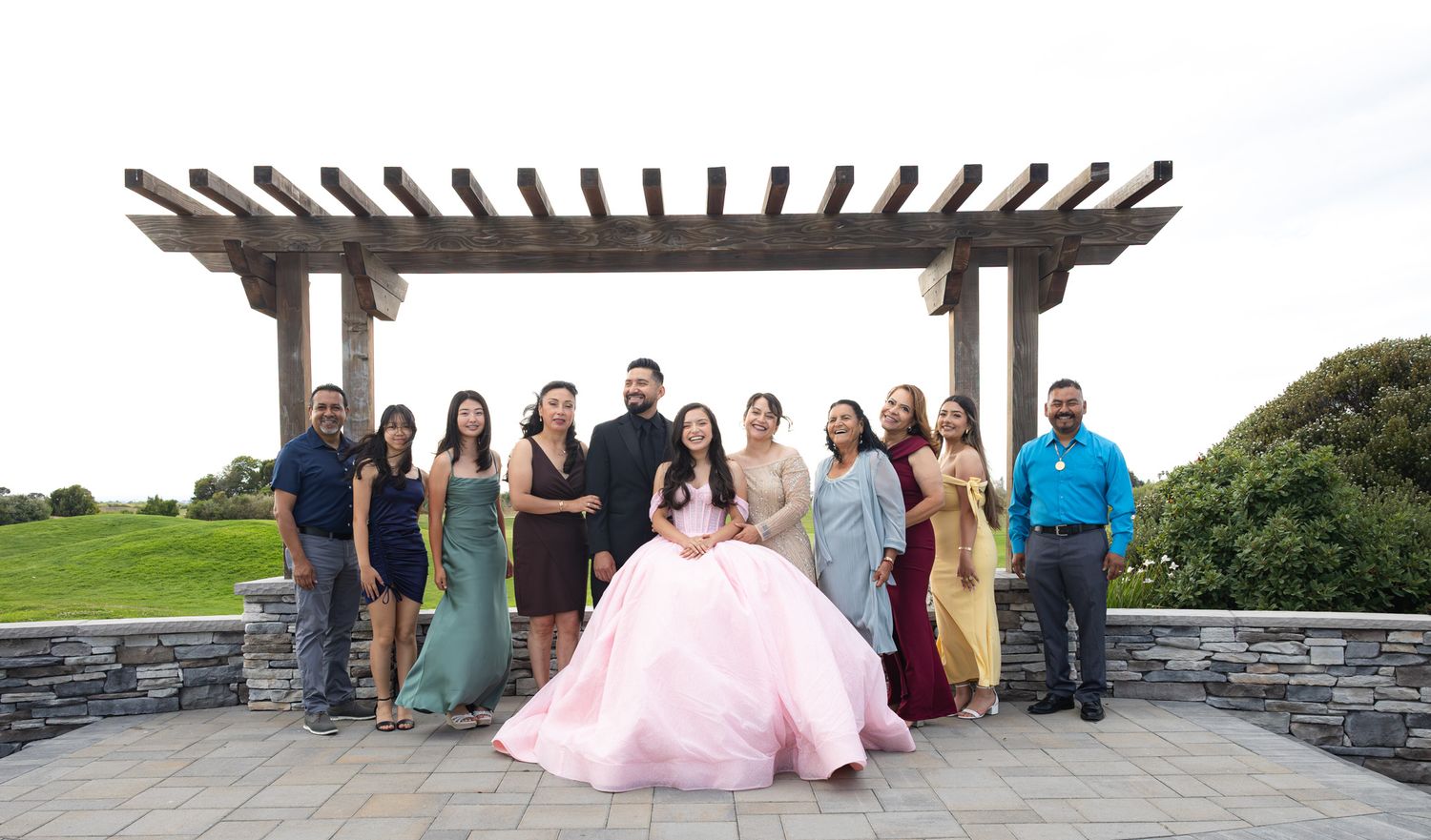 Outdoor family‑portrait of the photographer in bright natural light at the Oakland, CA quinceañera venue before the event.