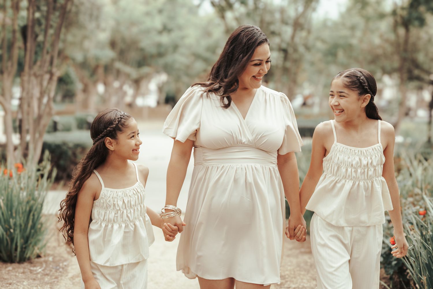 A collage of candid family moments captured outdoors in white dresses during a sunset photo session.