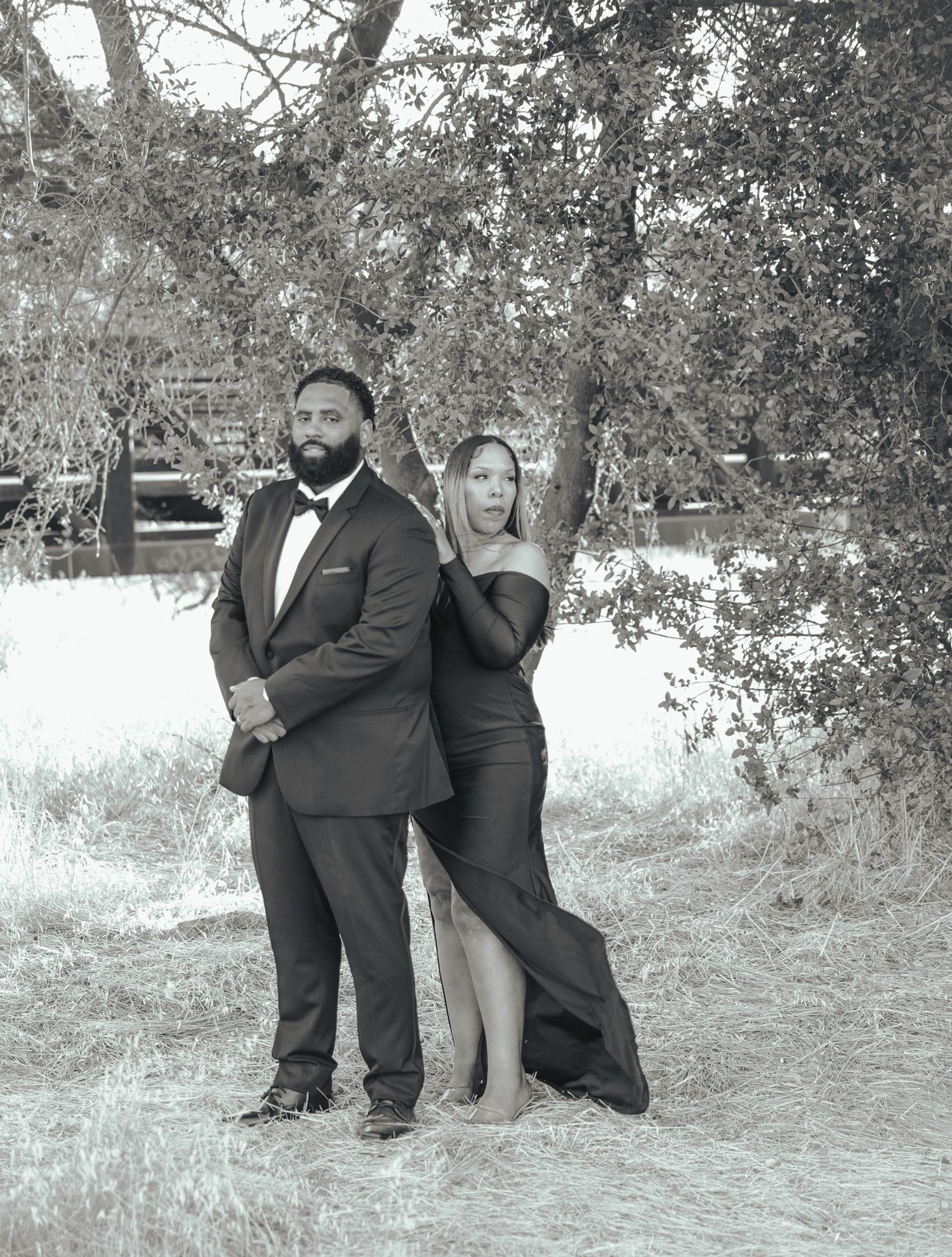 Black and white engagement photos showing couples posing together under trees in an outdoor setting.